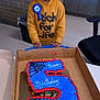 birthday, birthday_cake, boy, cake, celebration, chair, child, classroom, cupcakes, decorations, drawing, face, hoodie, indoor, number_5, person, ribbon, smiling, table, wall