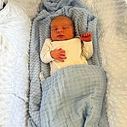 Freddie is registered to the contest to win money with this photo: newborn, baby, sleeping, blanket, blue_blanket, white_blanket, infant, cozy, soft, wrapped, peaceful, bed, texture, cute, small, resting, person, indoors, clothing, sleep