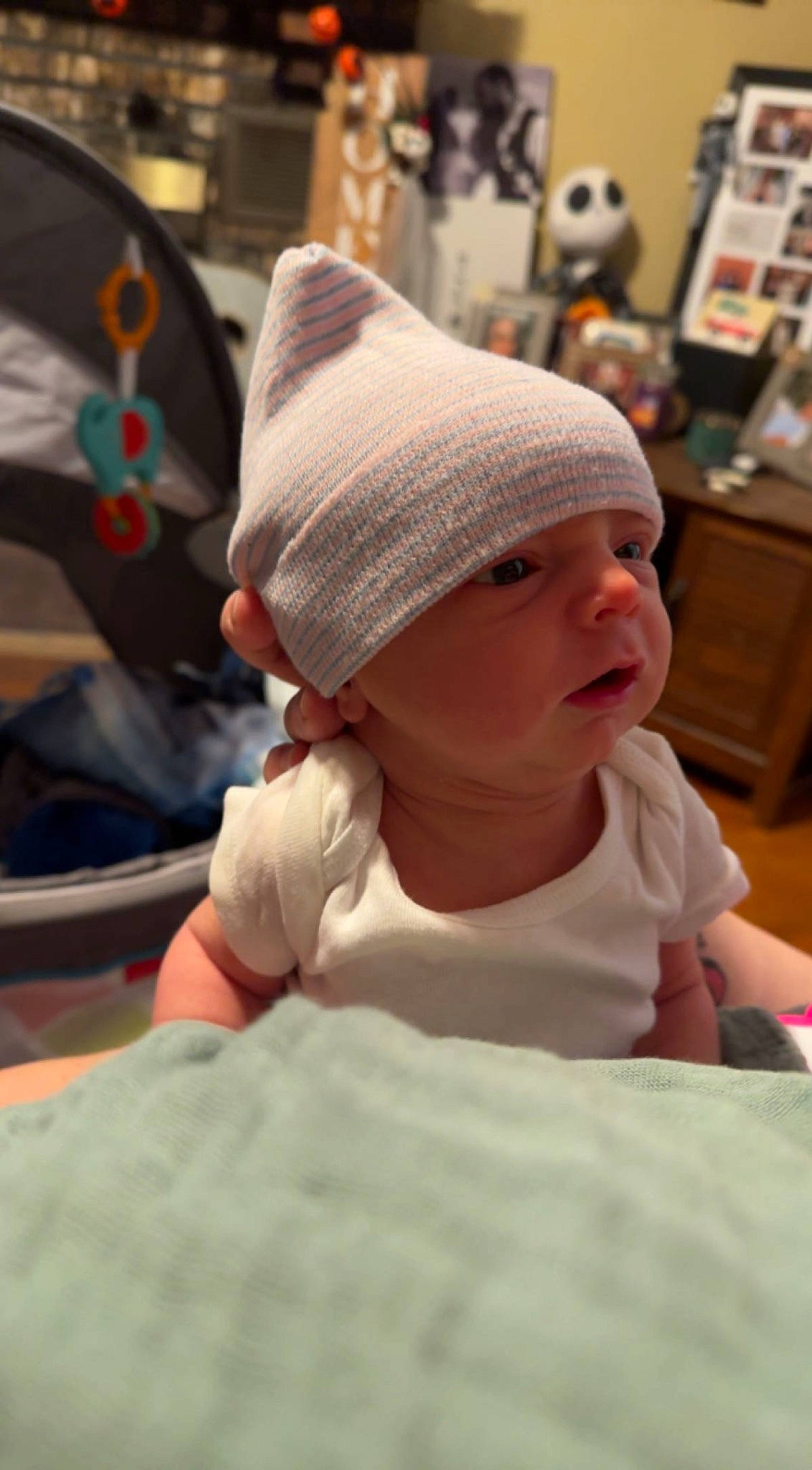 Bridger is registered to the contest to win money with this photo: baby, beanie, cap, child, comfort, fun, hat, headgear, headwear, knit_cap, leisure, linens, pattern, person, room, shelf, sitting, skin, smile, toddler