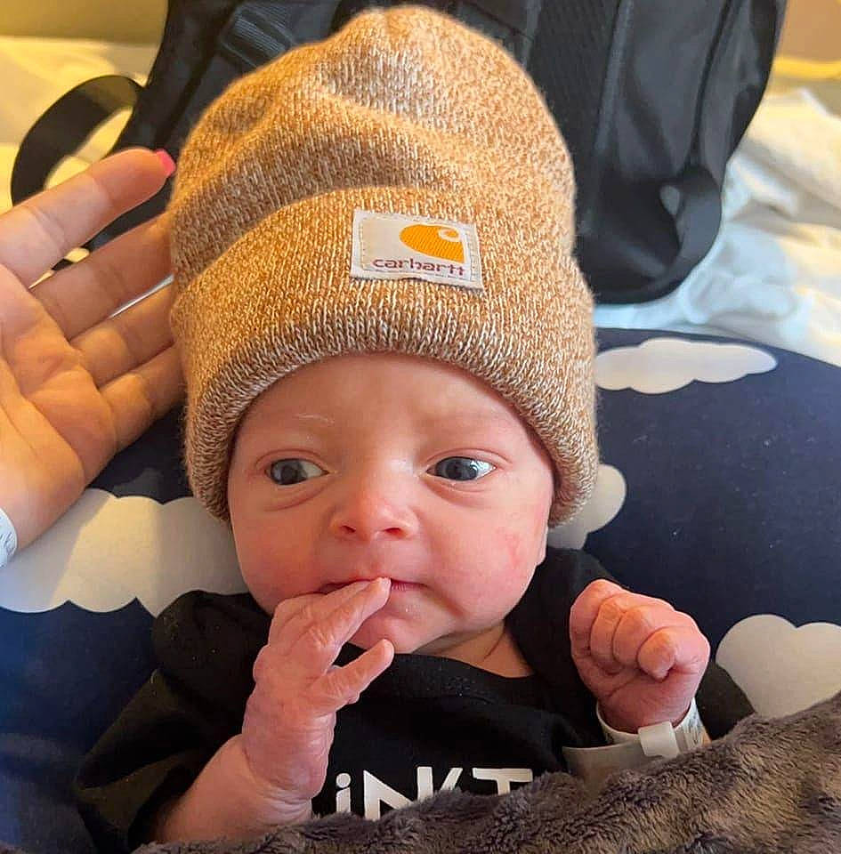 Bridger is registered to the contest to win money with this photo: baby, baby_sleeping, baby_toddler_clothing, cap, cheek, child, comfort, eye, eyelash, finger, gesture, head, headgear, headwear, lip, mouth, nail, nose, person, skin