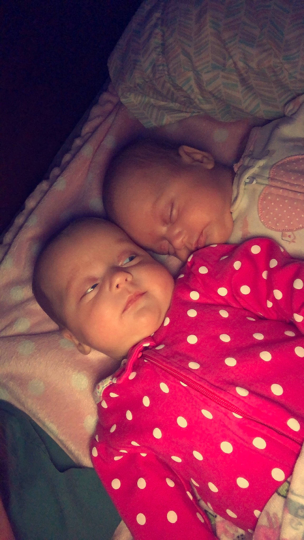 Dunnic Twins is registered to the contest to win money with this photo: baby, bedtime, cheek, child, comfort, facial_expression, finger, fun, happy, linens, lip, mouth, nose, organ, pattern, person, pink, room, skin, textile