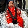 Laël participe au concours pour gagner de l'argent avec cette photo : baby, child, smiling, orange_tracksuit, blue_beanie, car_seat, seatbelt, indoor, blanket, white_socks, happy, infant, cute, person, young_child, clothing, comfort, baby_smile, portrait, cozy