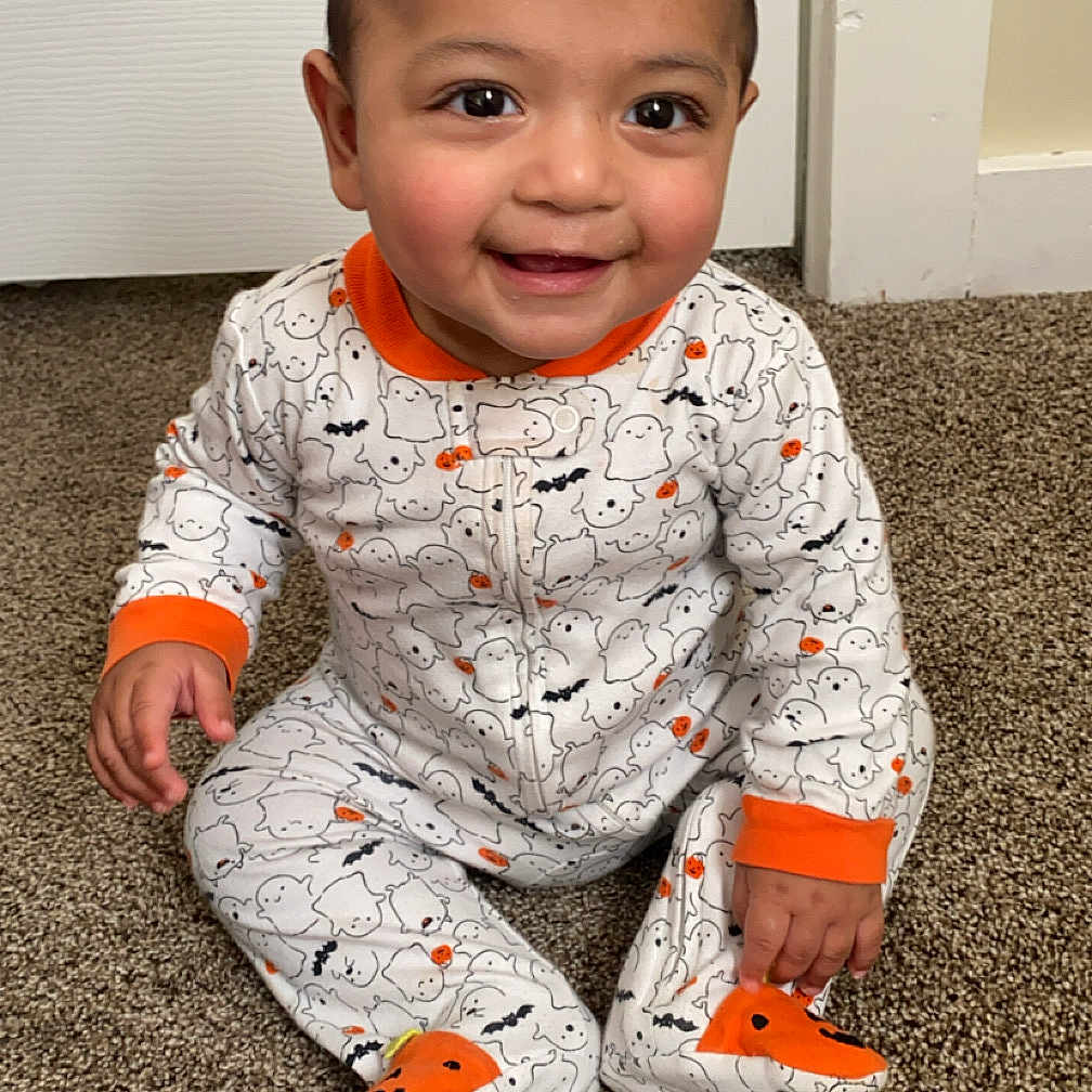 Zain joined the competition — help win amazing prizes! baby, bodypart, clothing, door, face, finger, footwear, hand, happy, head, mouth, pajamas, pants, person, photography, portrait, shoe, sitting, smile, teeth