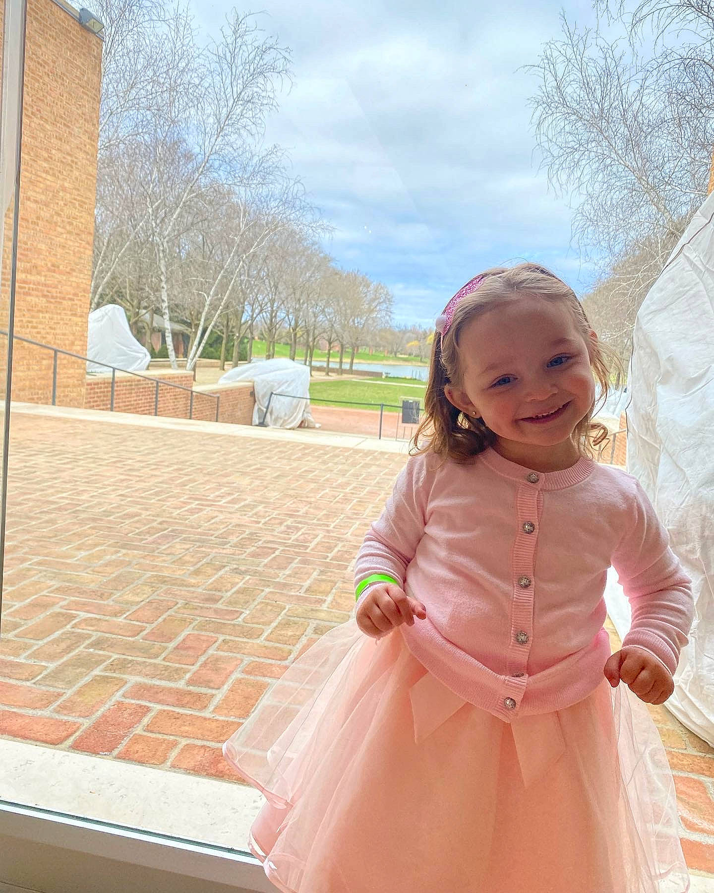 Kelsey is registered to the contest to win money with this photo: baby_toddler_clothing, child, cloud, dress, event, formal_wear, fun, grass, happy, joy, leisure, magenta, peach, person, pink, plant, sky, smile, standing, toddler