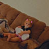 baby, child, couch, sofa, pacifier, toy, butterfly_toy, blanket, pillow, indoor, living_room, infant, sitting, clothing, face, feet, cute, digital_filter, pink_horns, relaxing