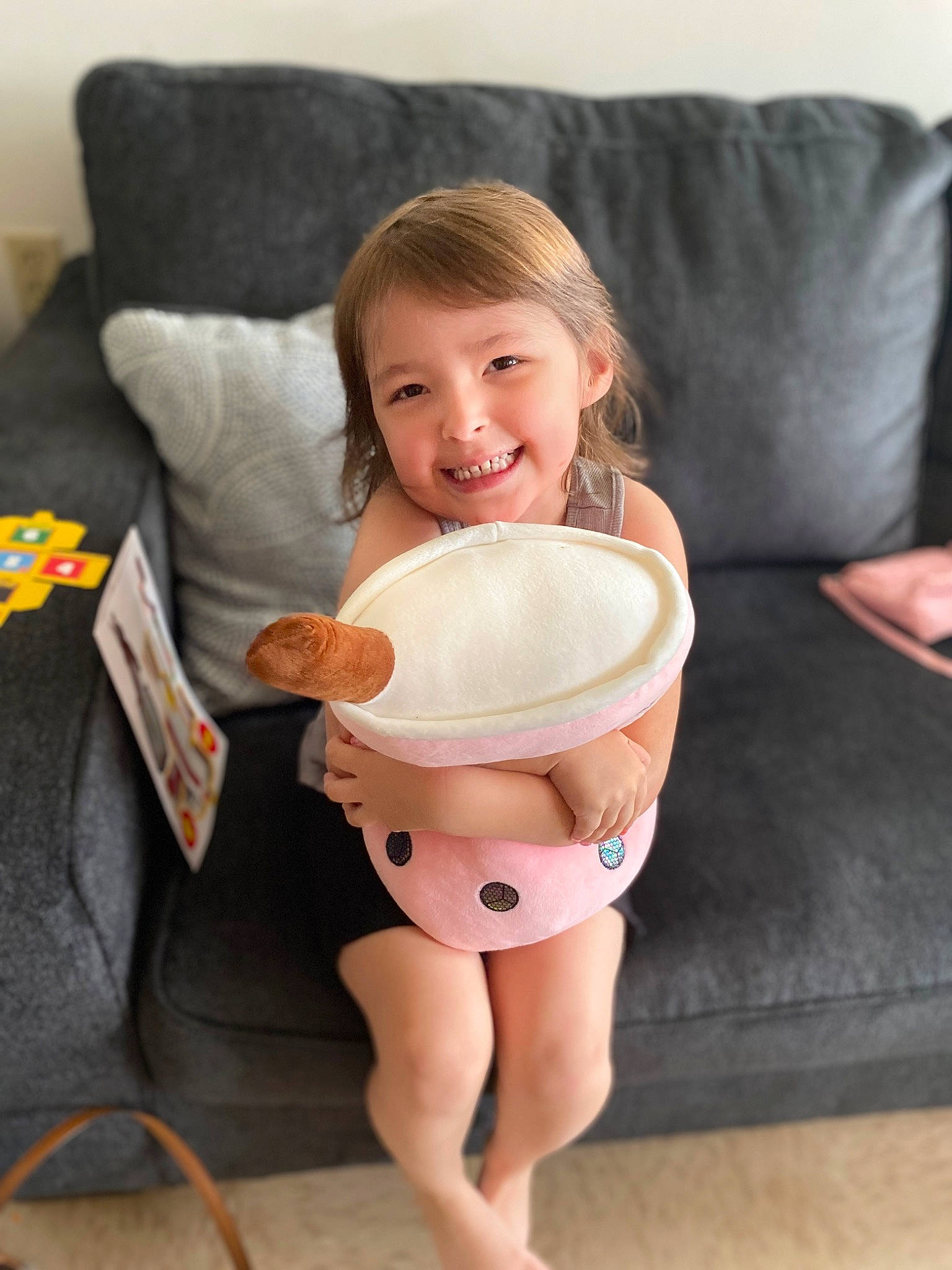 Raelyn is registered to the contest to win money with this photo: abdomen, baby, barefoot, chest, comfort, couch, face, finger, hair, happy, head, human_body, joy, leg, person, shorts, smile, stomach, table, tableware