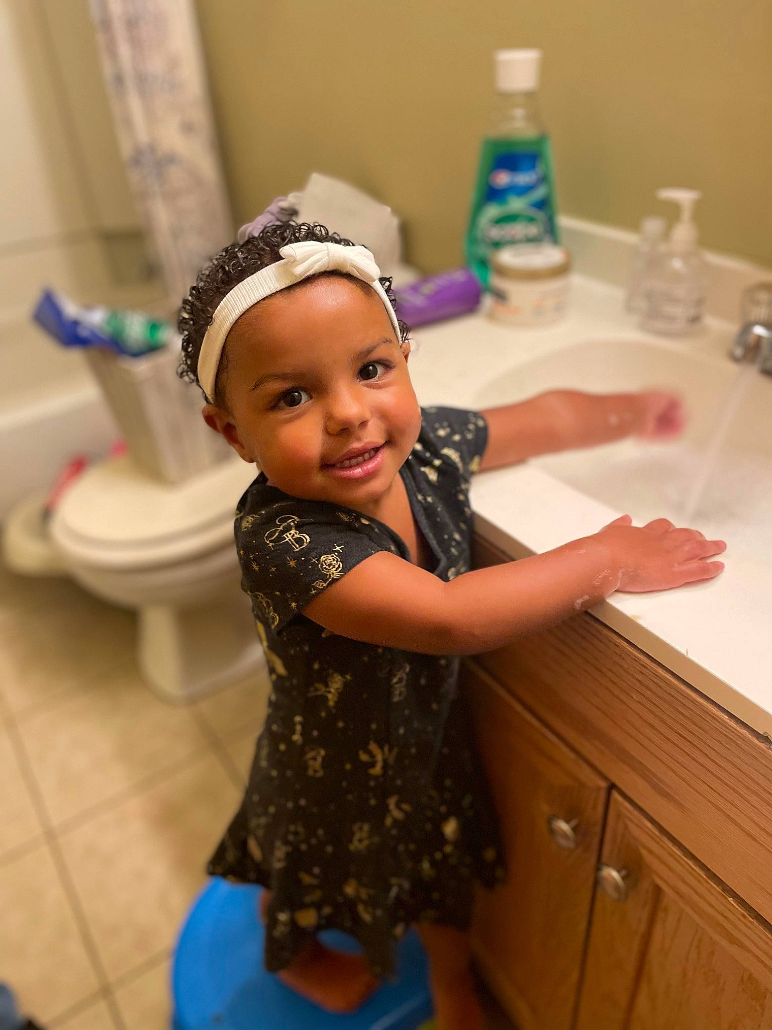 Kyrah joined the competition — help win amazing prizes! bathing, bathroom, blue, cap, child, countertop, finger, flooring, fun, hand, happy, headwear, joy, person, plumbing, plumbing_fixture, purple, room, skin, smile