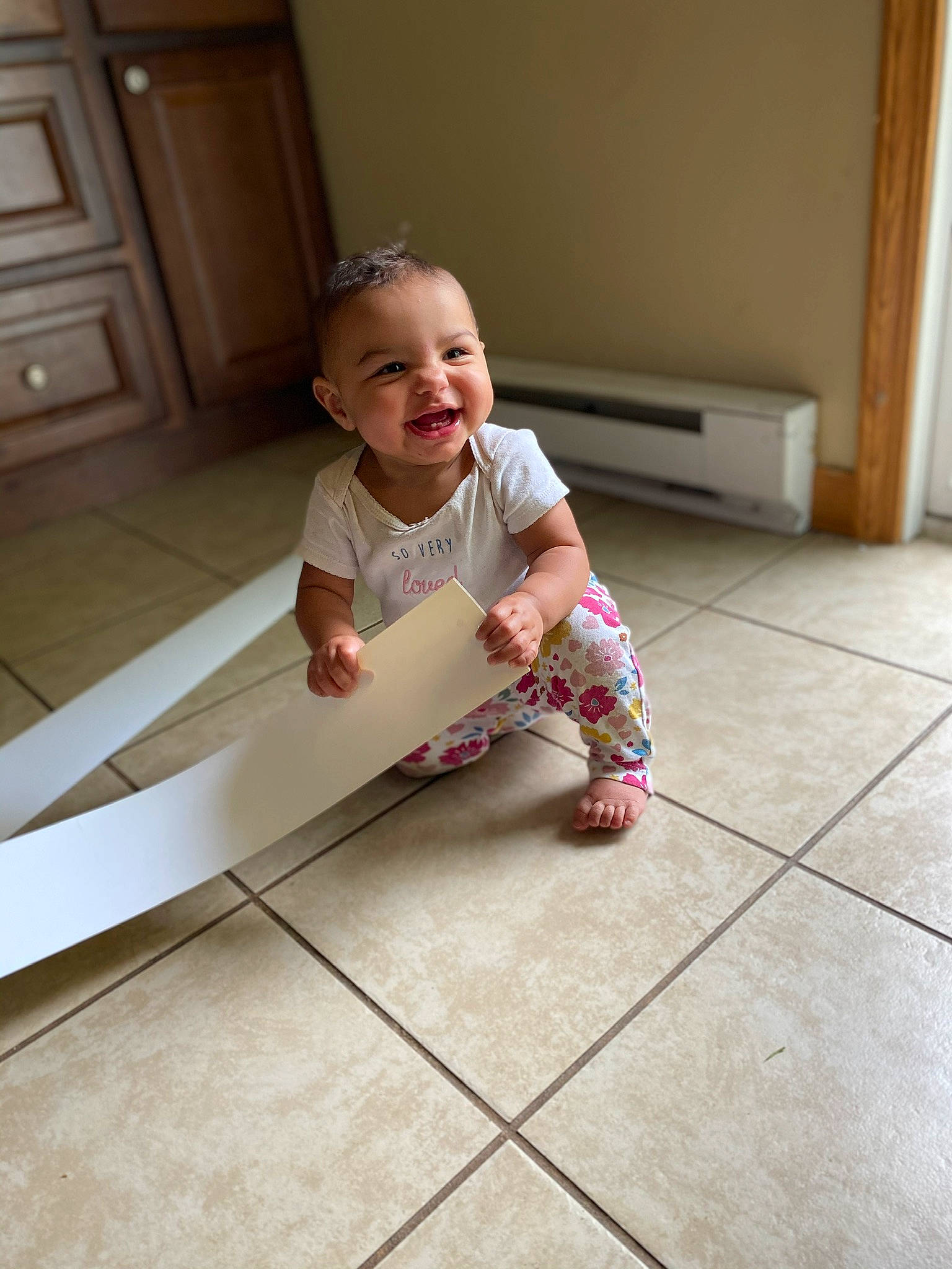 Kyrah is registered to the contest to win money with this photo: baby, child, crawling, floor, flooring, joy, leg, person, play, product, sitting, skin, tile, toddler, wood