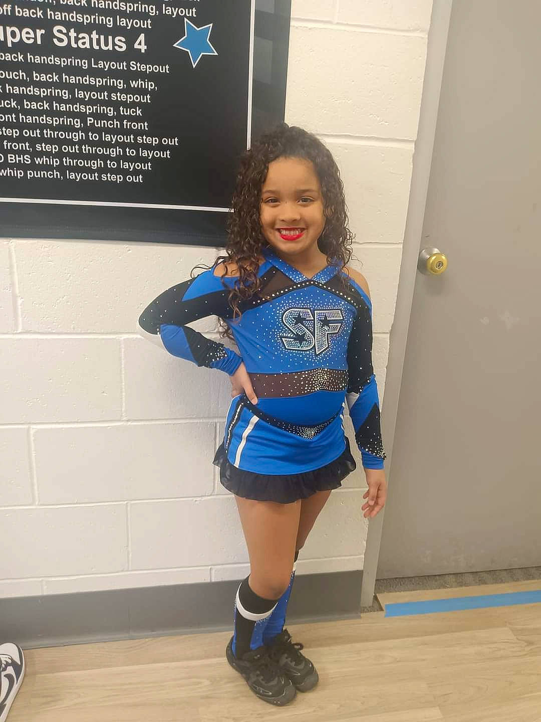 Skylynn joined the competition — help win amazing prizes! cheerleading_uniform, electric_blue, happy, human_leg, joy, knee, leg, person, school_uniform, shoe, shorts, sleeve, smile, sneakers, sports_uniform, sportswear, t_shirt, thigh, toddler, trunk