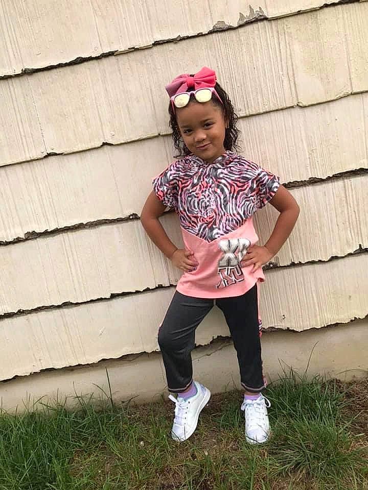 Skylynn is registered to the contest to win money with this photo: baby_toddler_clothing, child_model, clothing, costume_accessory, hair_accessory, headband, headpiece, headwear, joy, magenta, person, pink, shoe, sneakers, style, t_shirt, toddler, walking_shoe