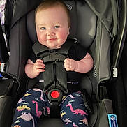 Aurelia is registered to the contest to win money with this photo: baby, car_seat, child, dinosaur_pants, infant, seat_belt, smile, cute, socks, clothing, straps, happy, young_child, indoor, person, safety, head, face, hands, transportation