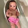 Aurelia is registered to the contest to win money with this photo: baby, bathtub, water, pink_towel, bath_seat, child, skin, wet, blue_eyes, infant, cute, relaxing, bath_time, indoors, person, young_child, plump, sitting, looking, curious