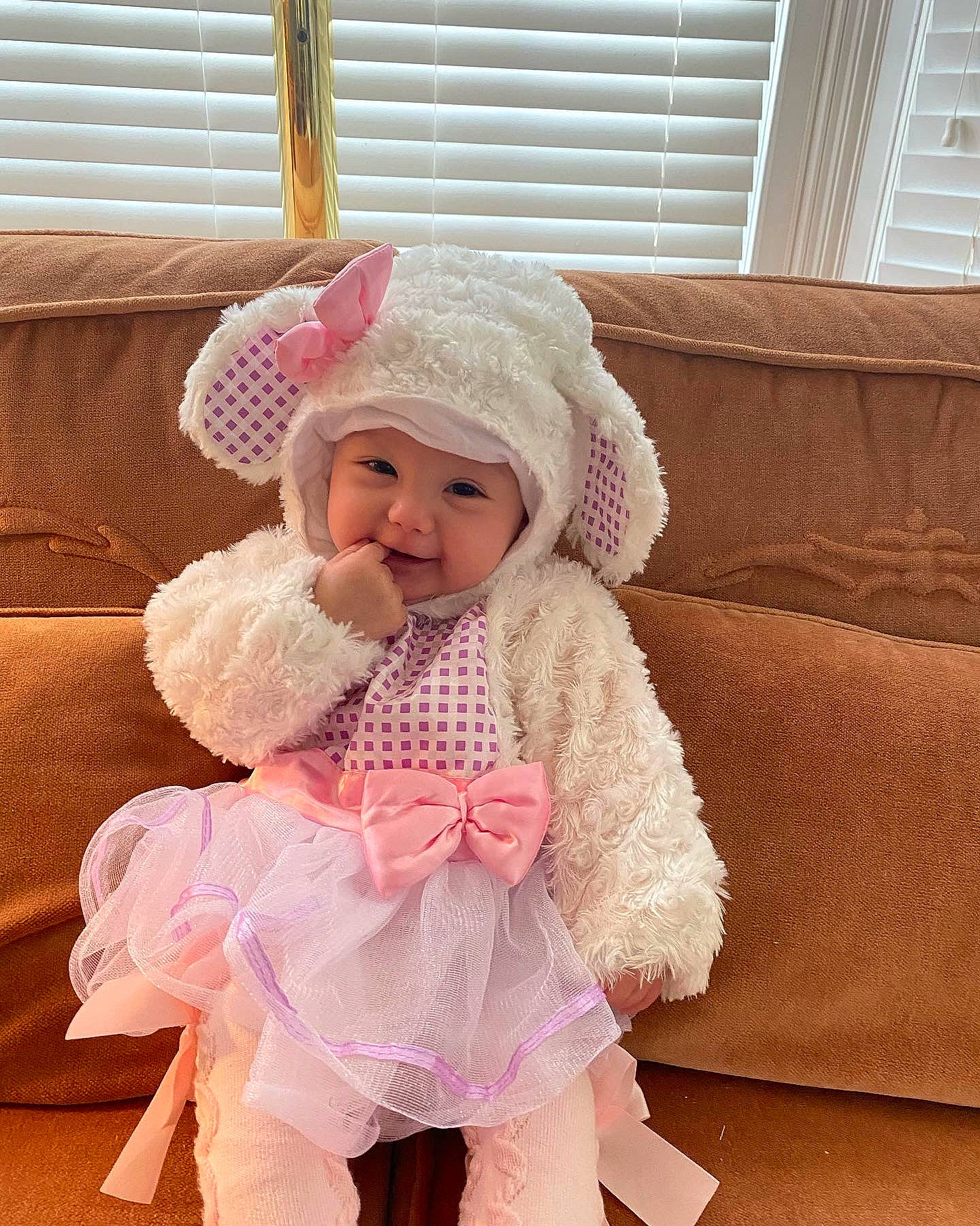 Angelina is registered to the contest to win money with this photo: baby, baby_toddler_clothing, cap, child, comfort, couch, embellishment, fashion_accessory, fur, happy, headgear, headwear, magenta, peach, person, pink, room, sleeve, textile, toddler