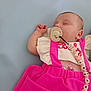 baby, sleeping, pacifier, pink_dress, infant, cute, child, rest, soft_background, close_up, clothing, person, peaceful, indoors, portrait, newborn, accessory, toddler, relaxation, sleep