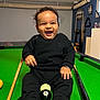 Kendrick participe au concours pour gagner de l'argent avec cette photo : baby, billiard_balls, black_clothing, child, cue_sticks, cute, fun, game_room, green_surface, happy, indoor, joyful, person, photography, playing, pool_table, recreation, sitting, smiling, young