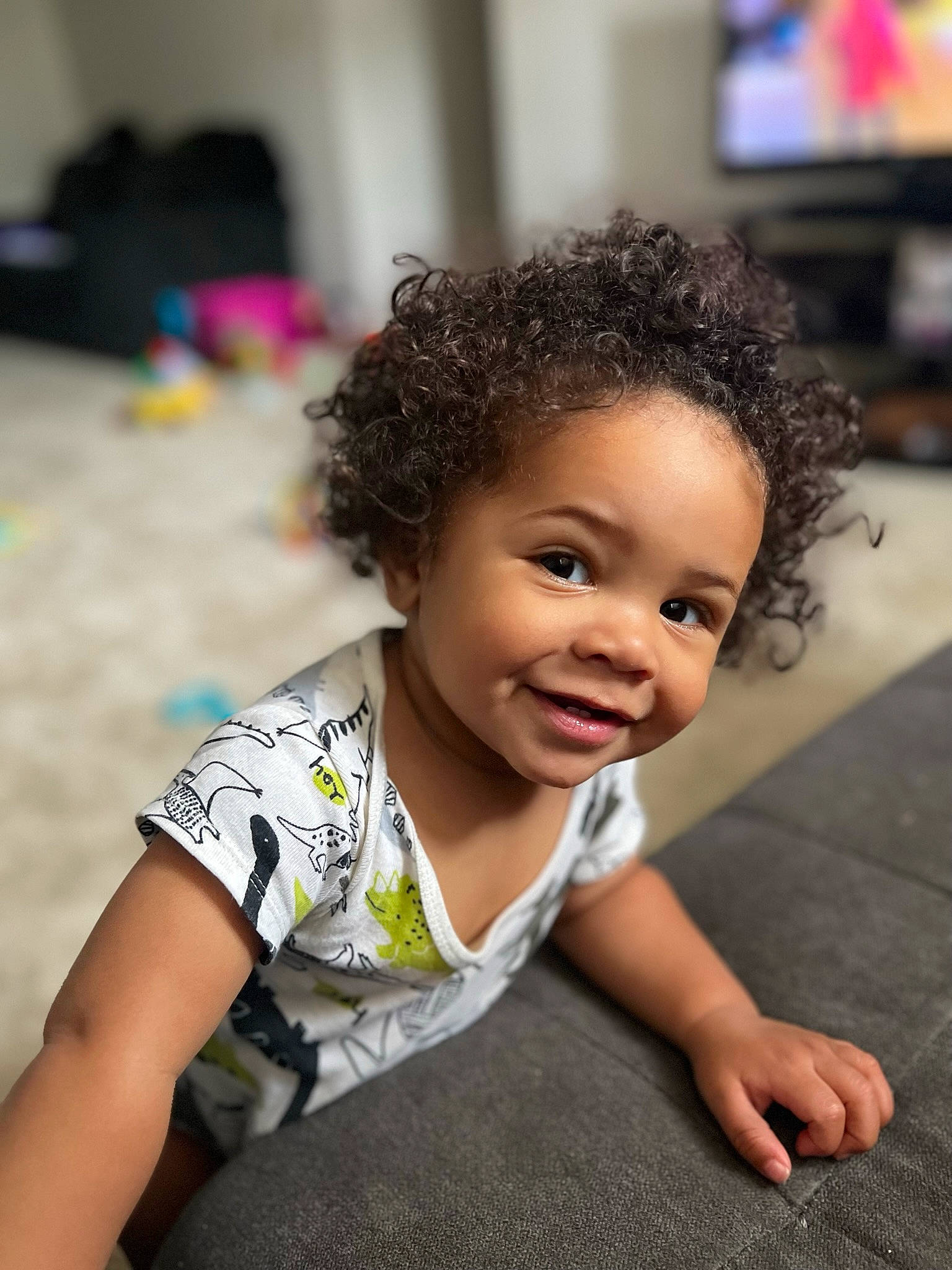 Isaiah is registered to the contest to win money with this photo: afro, arm, baby, black_hair, cheek, child, flash_photography, flooring, fun, grass, happy, joy, led_backlit_lcd_display, leisure, person, portrait_photography, sitting, skin, smile, t_shirt