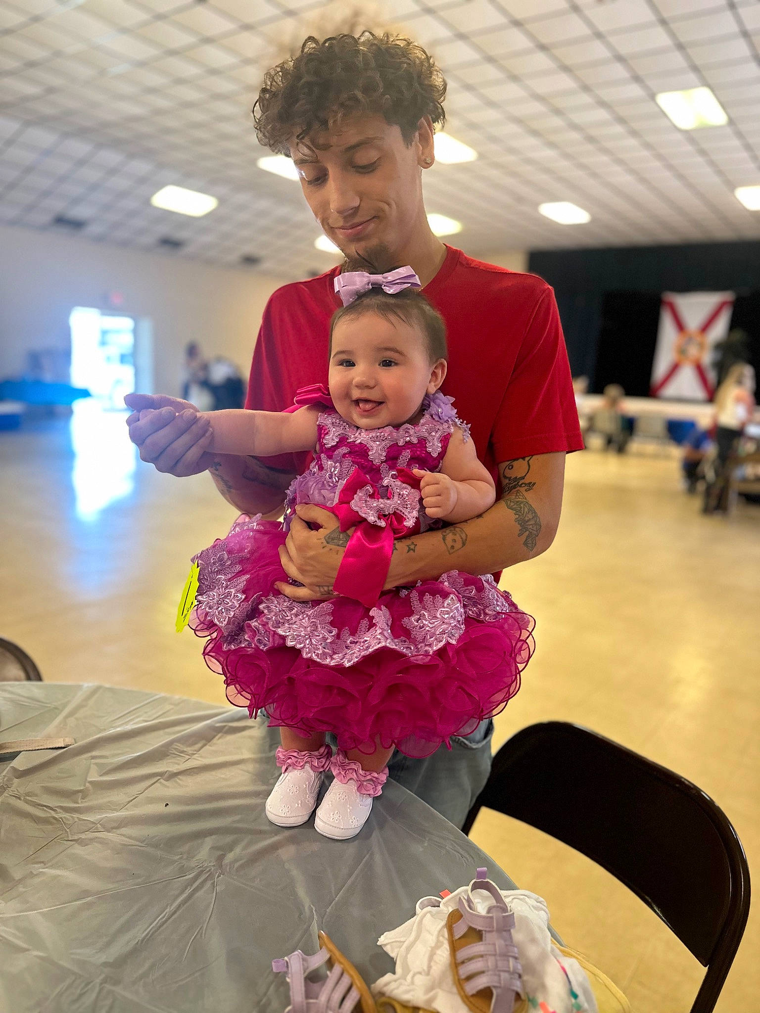 Zariyah is registered to the contest to win money with this photo: baby, birthday, chair, child, costume, entertainment, event, flooring, fun, happy, joy, leisure, magenta, party, performing_arts, person, purple, recreation, room, sitting