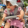 Hailey a rejoint le concours — aidez-le/la à gagner de superbes lots ! baby, bench, child, family, floral_outfit, foot, gathering, hand, nature, outdoor, pacifier, people, plush_toy, shade, stroller, summer, sunlight, table, trees, white_hat