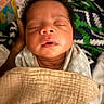 newborn, baby, infant, sleeping, face, portrait, swaddled, blanket, bedding, indoors, close_up, eyes_closed, peaceful, cozy, curly_hair, onesie, head, child, home, photography