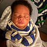 Nikolai is registered to the contest to win money with this photo: newborn, baby, sleeping, infant, portrait, face, curly_hair, closed_eyes, striped_clothing, blue_clothing, blanket, swaddled, cozy, indoors, closeup, resting, peaceful, seated, soft_lighting, child