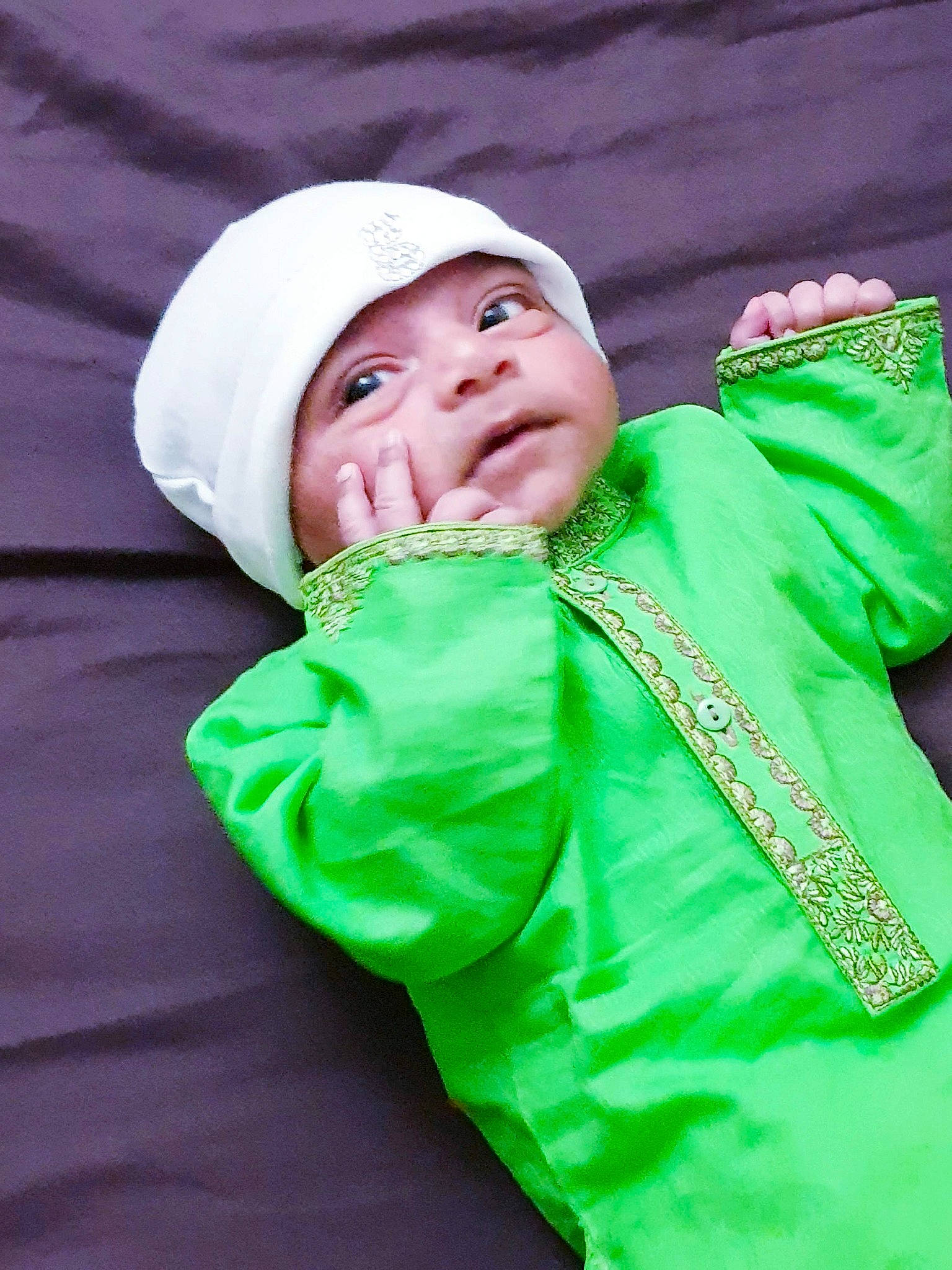Hassan is registered to the contest to win money with this photo: child, green, happy, head, headgear, headwear, outerwear, person, sleeve, smile