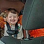 child, toddler, smile, smiling, car_seat, harness, seatbelt, headrest, vehicle_interior, rear_seat, orange_shirt, camo, hair, face, happy, portrait, seat, upholstery, child_safety, grin