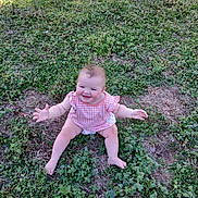 Mahala Logan joined the competition — help win amazing prizes! baby, infant, smiling, sitting, grass, outdoor, greenery, cute, chubby_cheeks, diaper, gingham_top, pink_clothing, bare_legs, happy, portrait, sunlight, nature, ground, playful, one_child