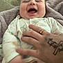 Carson joined the competition — help win amazing prizes! baby, infant, smile, laughing, hand, tattoo, blanket, diaper, clothing, person, happy, skin, cute, sleepwear, bed, cozy, playful, child, human, comfort