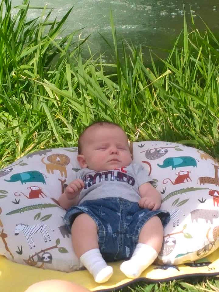 Clinton is registered to the contest to win money with this photo: baby, baby_products, baby_toddler_clothing, cheek, child, comfort, design, grass, grass_family, happy, leisure, pattern, people_in_nature, person, plant, sitting, skin, toddler, tree