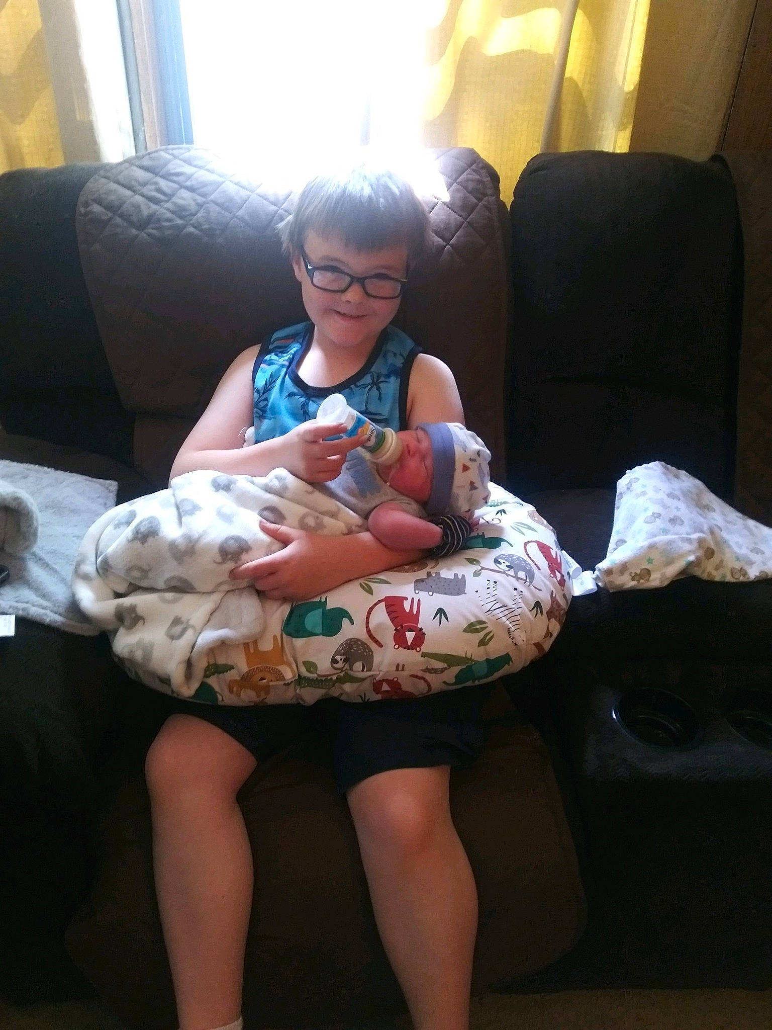 Johnathan is registered to the contest to win money with this photo: baby, child, comfort, couch, fun, glasses, human_body, human_leg, joint, joy, knee, lamp, lap, leg, mouth, person, room, shoulder, thigh, toddler