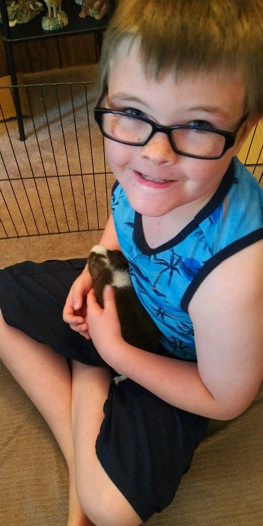 Johnathan is registered to the contest to win money with this photo: arm, black_hair, companion_dog, elbow, eye, eyewear, finger, glasses, hair, hairstyle, hand, happy, joy, mouth, neck, organ, person, shoulder, skin, smile