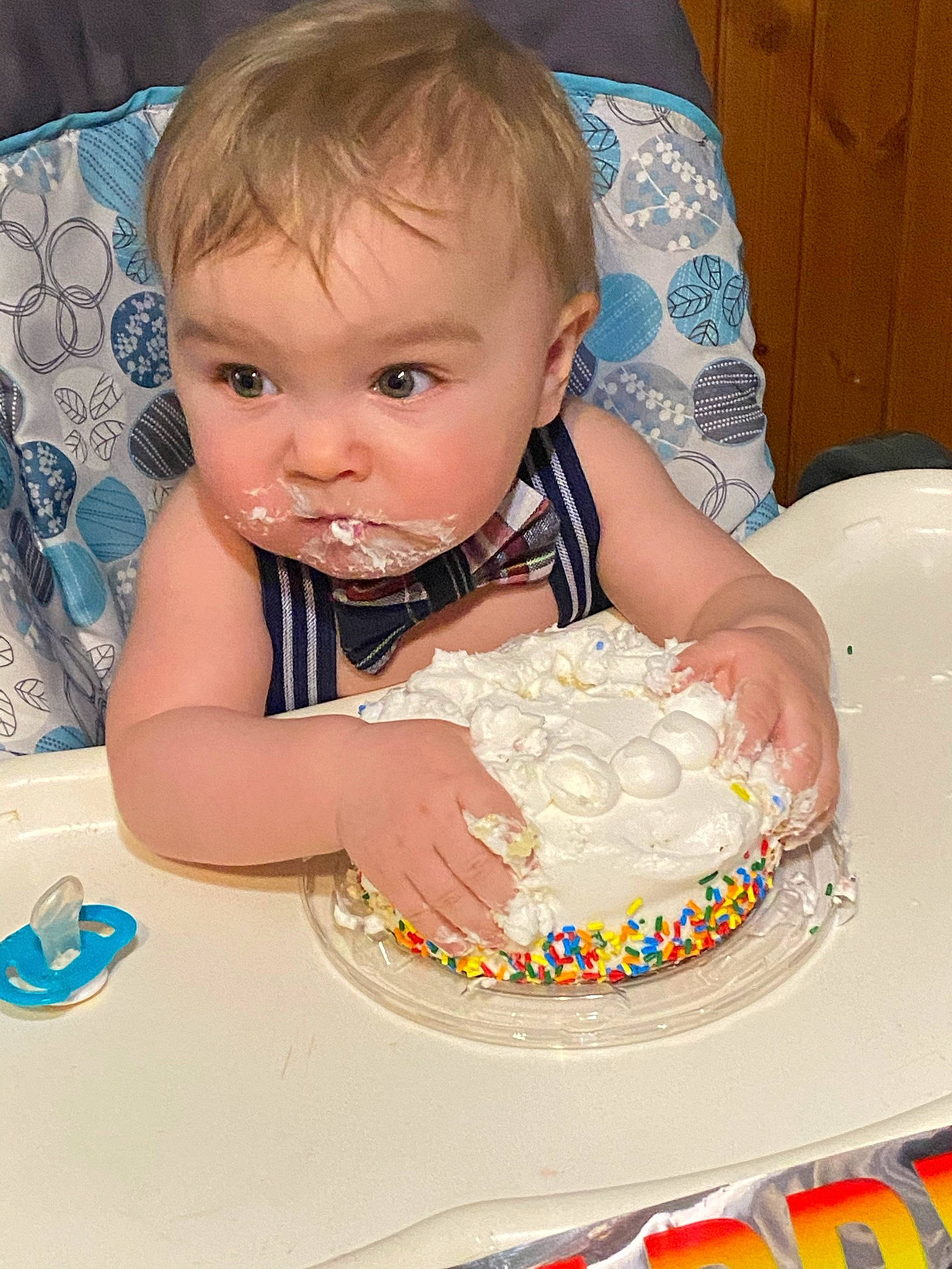 Jasper is registered to the contest to win money with this photo: baby, baby_playing_with_food, baby_products, baby_toddler_clothing, birthday, birthday_cake, birthday_party, blue, cake, cake_decorating, cake_decorating_supply, cheek, child, dessert, event, food, person, skin, sugar_cake, sweetness