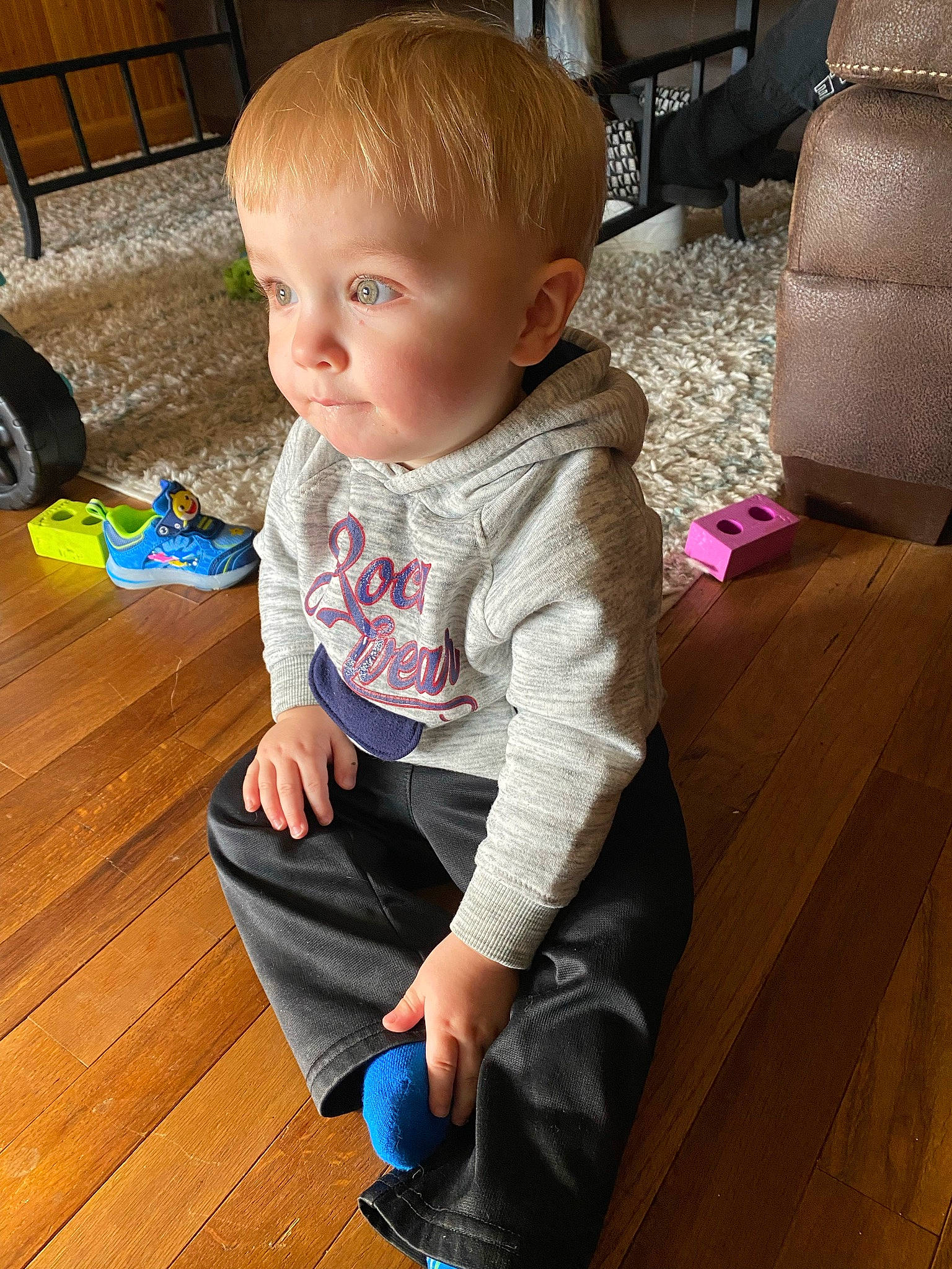 Jasper is registered to the contest to win money with this photo: baby, baby_toddler_clothing, cheek, child, comfort, floor, flooring, fun, hairstyle, hardwood, leg, person, product, skin, sleeve, sock, standing, tire, toddler, wheel