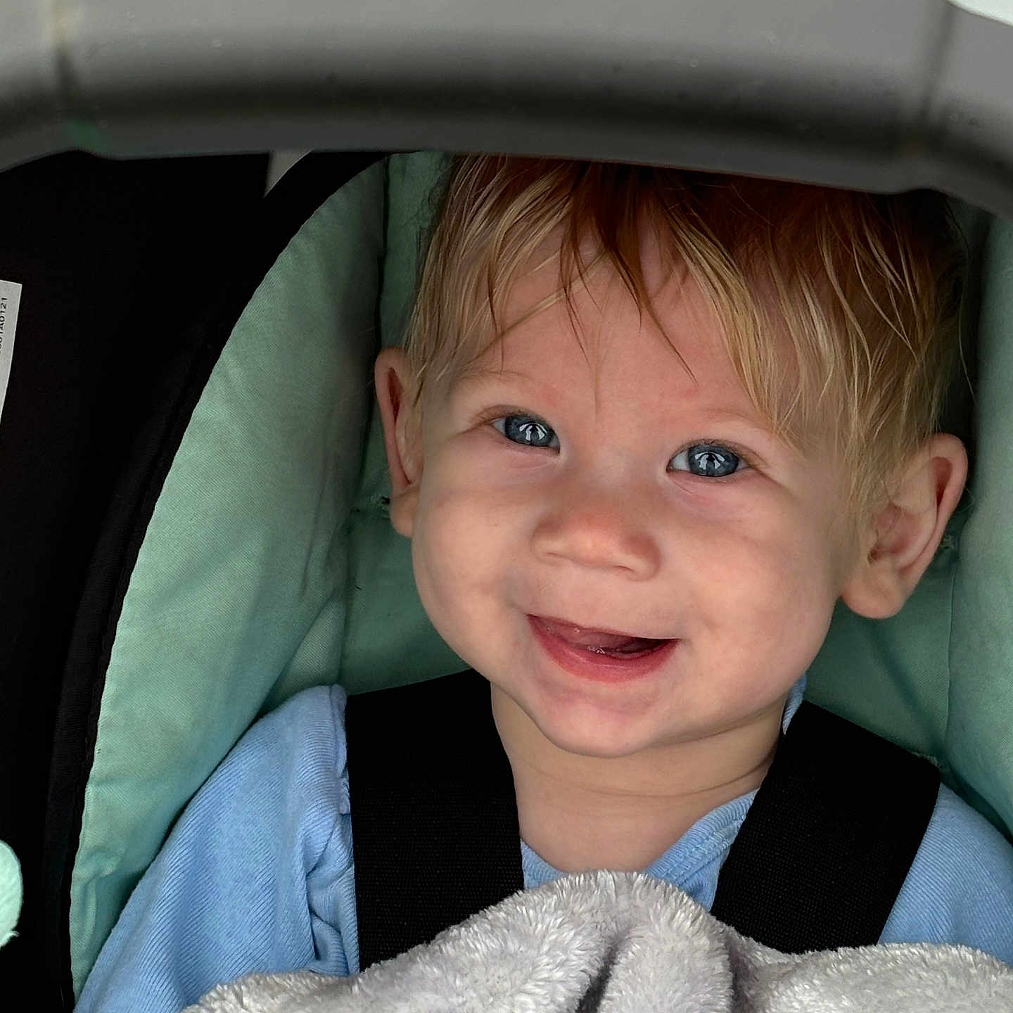 Axavier is registered to the contest to win money with this photo: baby, bodypart, car, clothing, coat, cushion, face, happy, head, homedecor, jacket, laughing, mouth, person, photography, portrait, smile, stroller, teeth, transportation