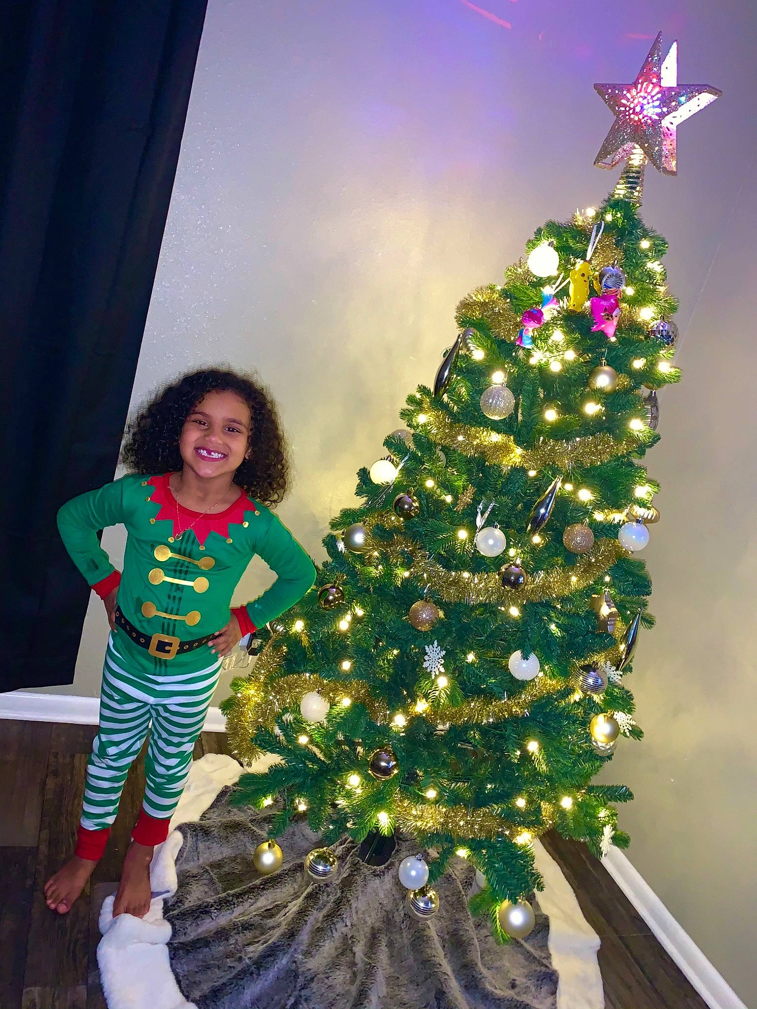 Keilani is registered to the contest to win money with this photo: architecture, child, christmas, christmas_decoration, christmas_eve, christmas_ornament, christmas_tree, colorado_spruce, conifer, event, fir, holiday, interior_design, joy, person, pine, pine_family, plant, toddler, tradition