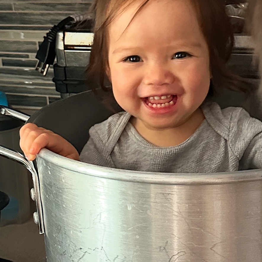 Belladonna is registered to the contest to win money with this photo: appliance, baby, babylaughing, bodypart, bucket, cooker, device, face, finger, food, hand, happy, head, laughing, mouth, person, photography, portrait, smile, teeth