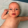 baby, infant, child, skin, face, eyes, mouth, arm, torso, medical_table, blue_background, newborn, cute, human, expression, lying_down, bare_chest, indoors, healthy, young