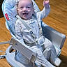 Grayson is registered to the contest to win money with this photo: baby, baby_seat, child, clothing, cute, expression, fisher_price, furniture, happy, indoor, infant, onesie, person, playful, seat, smiling, straps, toy, wooden_floor, young
