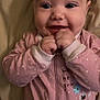 baby, child, smiling, face, hands, onesie, pink_clothing, polka_dots, happy, infant, cute, portrait, eyes, mouth, fingers, sleeves, zipped, indoor, soft_light, expression