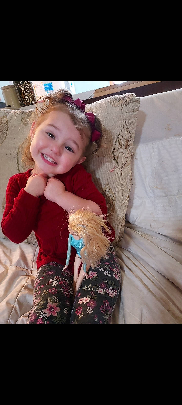 Shevelle is registered to the contest to win money with this photo: baby_toddler_clothing, blond, brown_hair, child, comfort, couch, fashion_accessory, fur, happy, joy, linens, magenta, pattern, person, pink, room, sitting, skin, sleeve, smile