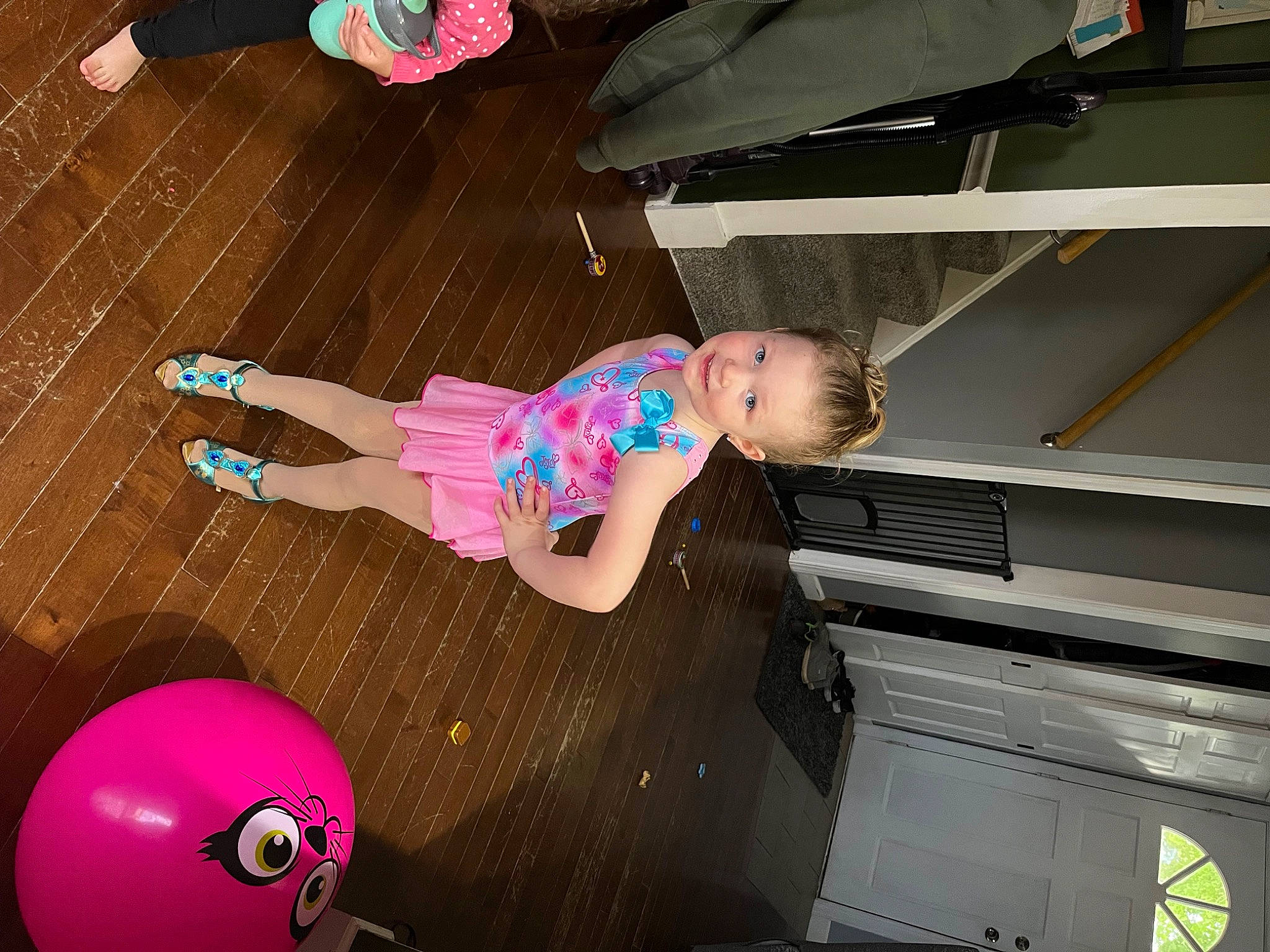 Madelyn is registered to the contest to win money with this photo: baby, baby_products, baby_toddler_clothing, child, flooring, fun, hardwood, human_leg, joy, leisure, magenta, pattern, person, pink, play, room, sandal, thigh, toddler, wood