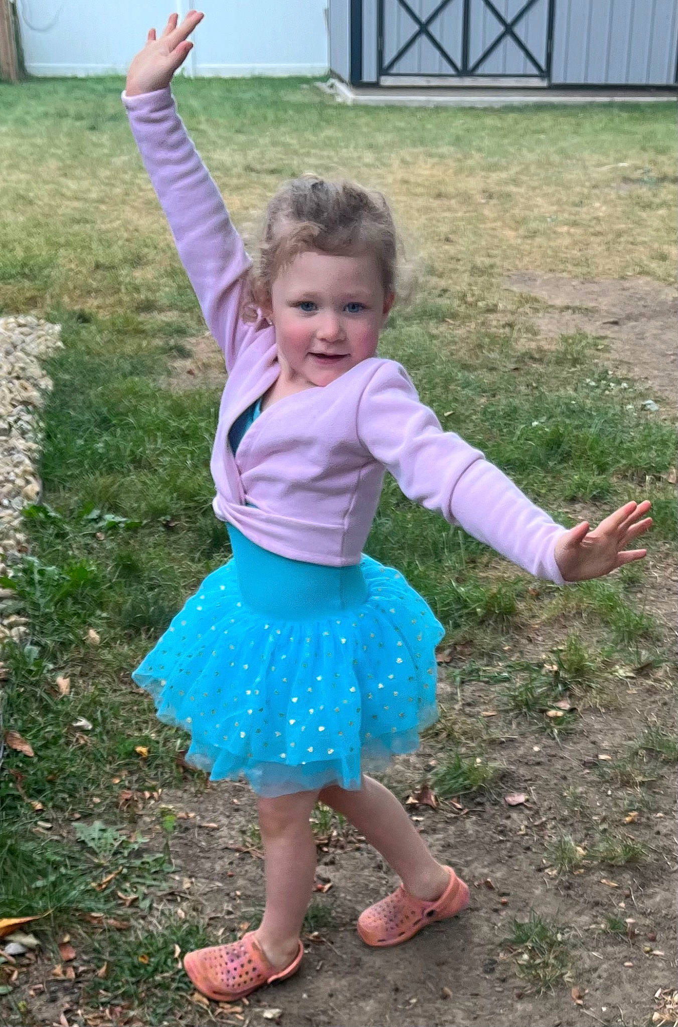 Madelyn is registered to the contest to win money with this photo: baby_toddler_clothing, barefoot, child, electric_blue, eye, foot, fun, grass, grass_family, happy, joy, leisure, magenta, pattern, people_in_nature, person, plant, sandal, sleeve, standing