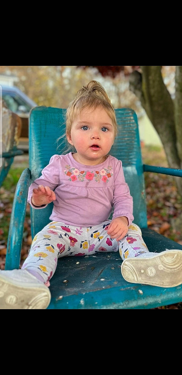 Sophia is registered to the contest to win money with this photo: baby, baby_products, baby_toddler_clothing, child, facial_expression, fun, grass, happy, leisure, magenta, person, pink, play, portrait_photography, purple, recreation, sitting, toddler, tree, vacation