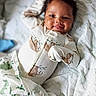 baby, infant, child, smiling, portrait, lying_down, blanket, bed, bedding, onesie, mittens, nursery, indoor, cozy, happy, face, eyes, hair, candid, photography