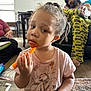 Amiyah is registered to the contest to win money with this photo: child, face, marker, messy, tshirt, sitting, carpet, indoor, adult, pajamas, batman, relaxed, family, person, curious, hair, dreadlocks, living_room, furniture, window