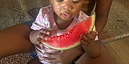 Alaina joined the competition — help win amazing prizes! toddler, watermelon, child, person, fruit, indoor, floor, diaper, hand, legs, sitting, emotional, tear, clothing, skin, holding, snack, casual, caregiver, comfort