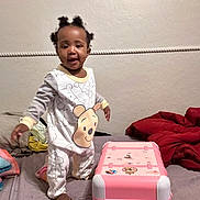 Alaina is registered to the contest to win money with this photo: toddler, child, pajamas, bed, blanket, toy, suitcase, indoor, smiling, standing, person, cute, play, furniture, room, home, sleepwear, footwear, skin, hair