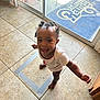 Alaina joined the competition — help win amazing prizes! toddler, child, smiling, indoors, tile_floor, braided_hair, barefoot, white_shirt, happy, arms_outstretched, glass_door, door_mat, st_louis_rams, sunlight, home, person, cute, playful, floor, standing