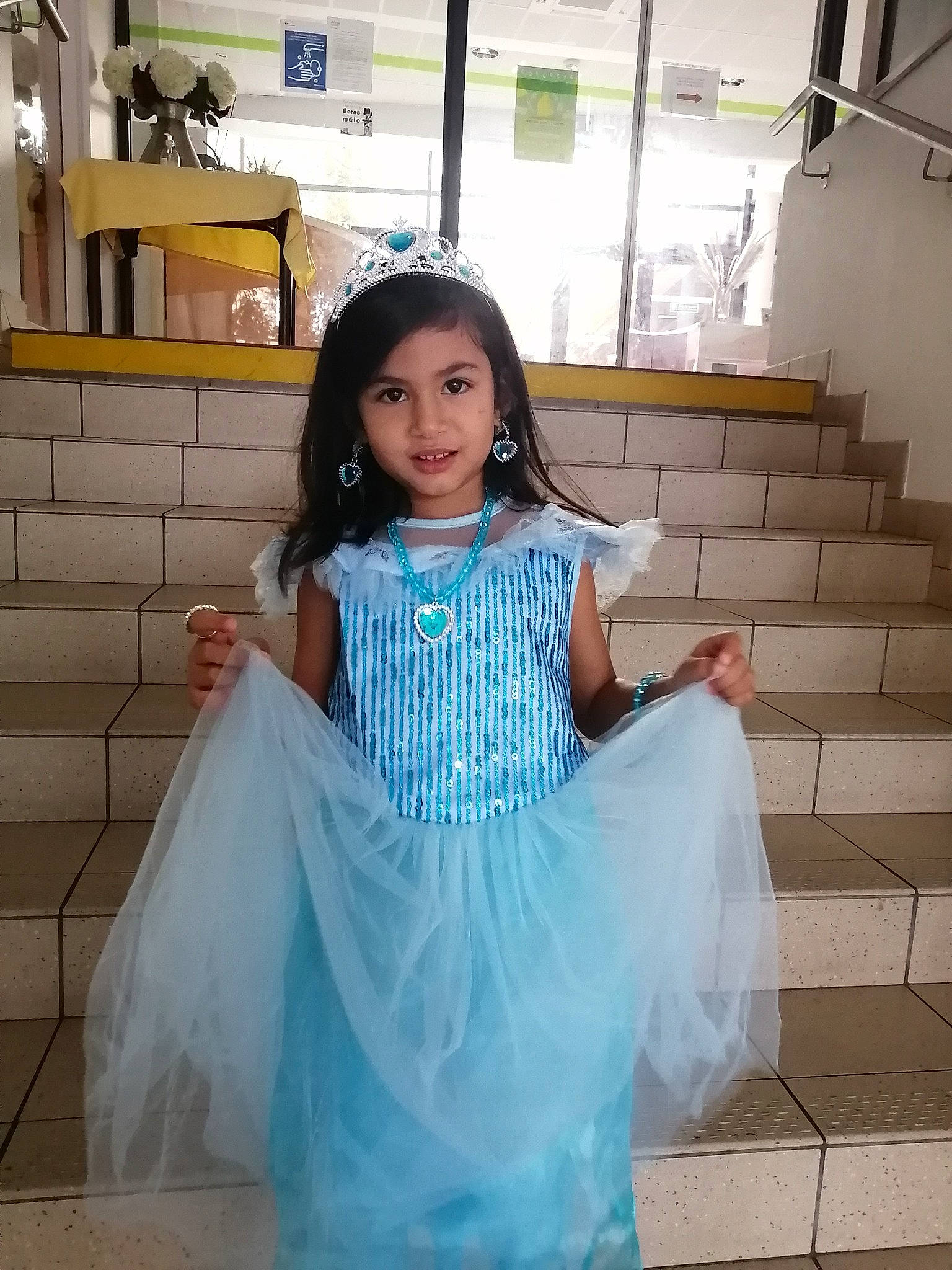 Sarah participe au concours pour gagner de l'argent avec cette photo : abdomen, aqua, black_hair, bridal_clothing, bridal_party_dress, day_dress, dress, embellishment, fashion_design, flash_photography, gown, hairstyle, happy, headpiece, joy, one_piece_garment, person, shoulder, sleeve, standing