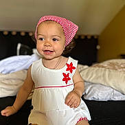 Gëovanna participe au concours pour gagner de l'argent avec cette photo : toddler, child, smiling, headscarf, red, white, dress, flower, bed, pillow, indoor, happy, cute, person, clothing, sitting, portrait, baby, young_child, skin